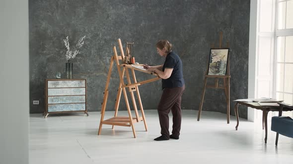 Senior Female Artist Painting in the Art Studio alt