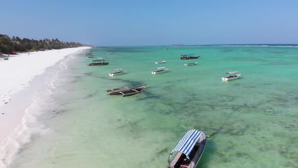 Boats are Anchored Off the Coast on Shallow Ocean at Low Tide Aerial Zanzibar alt