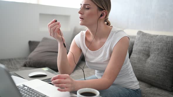 Video Conference, Virtual Event Concept - Happy Young Woman in Headphones Working and Making a Video