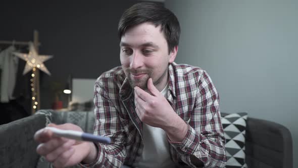 Future Young Father is Very Happy About News of Pregnancy Holds Pregnancy Test and is Incredibly alt