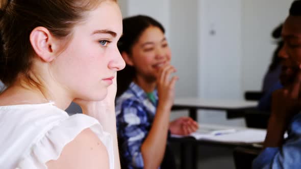 School friends bullying a sad girl in classroom alt