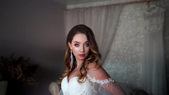 The Girl After Applying Makeup Poses in Front of the Camera While Moving alt