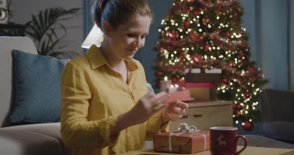 Woman receiving a beautiful Christmas gift
