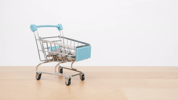 Stop motion animation Money stack on shopping cart, Money saving and economy concept.