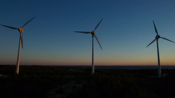 Wind power generation at sunset. alt