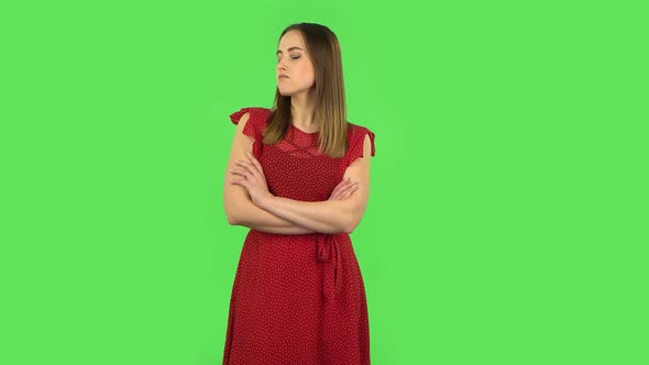 Tender Girl in Red Dress Is Standing Offended and Then Smiling. Green Screen alt