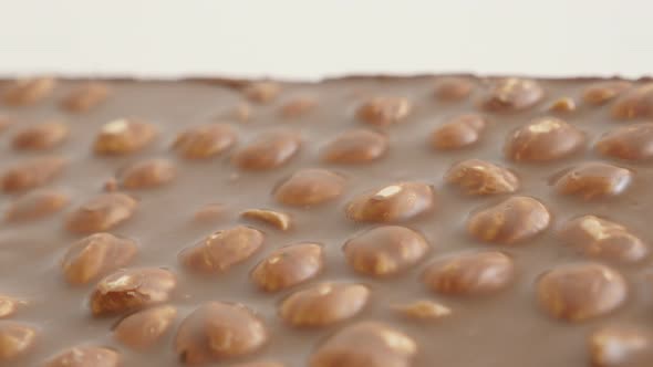 Slow pan on texture of tasty dessert  4K 2160p 30fps UltraHD footage - Milk chocolate with whole haz alt
