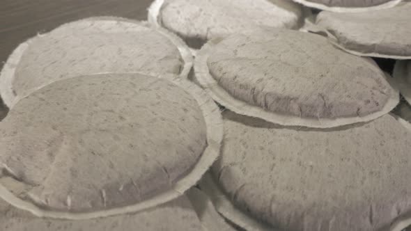 Paper coffee pod lot on wooden table dolly slider close-up 4K 2160p UHD footage - Dolly sliding to l alt