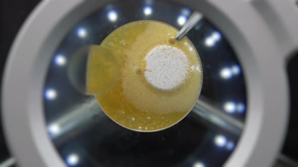 Tablet Dissolves in Liquid Under a Microscope alt