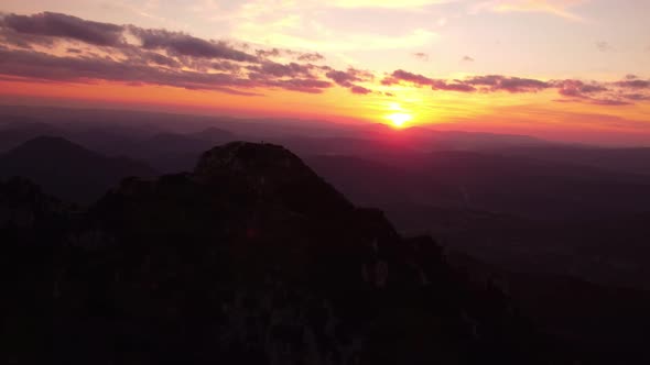 Aerial View Silhouette of a Mountain in a Hilly Landscape at Sunset