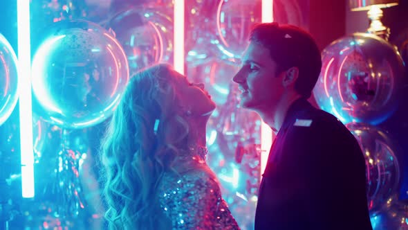 Charming Girl and Guy Moving in Dance in Club. Man Touching Girl Face at Party alt