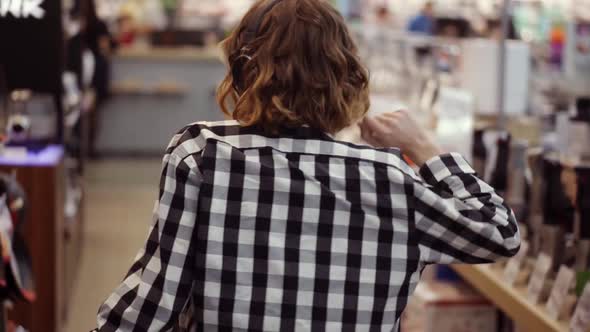 Rare View of Cute Caucasian Pretty Young Woman with Short Curly Hair and in Headphones Dancing and alt