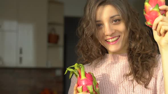 Young Girl is Holding Two Fresh Ripe Organic Dragon Fruits or Pitaya Pitahaya alt