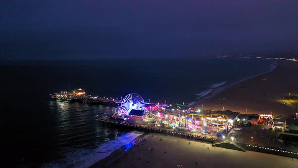 Ferris wheel and roller coaster at the Santa Monica Pier in southern California. alt