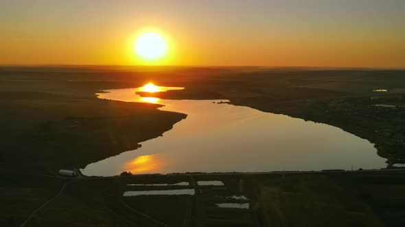 Aerial drone view of nature in Moldova at sunset. Lakes, village, road, wide fields alt