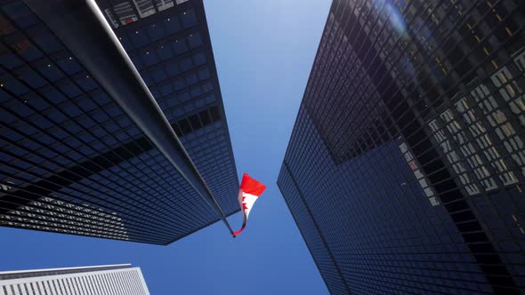 Rotating Around Tall Office Buildings Downtown With Tall Canadian Flag In Daylight 2