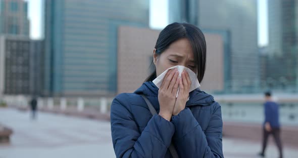 Woman Sneezing at Outdoor alt