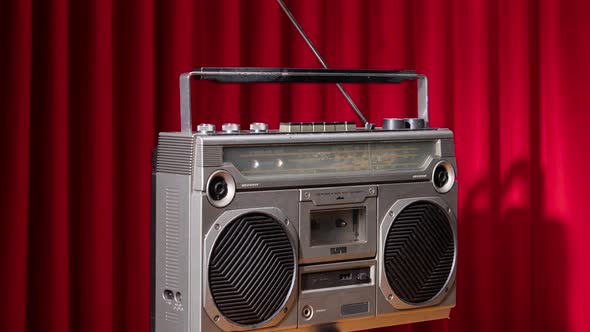 Spinning Ghettoblaster Agaisnt Red Velvet Curtain alt