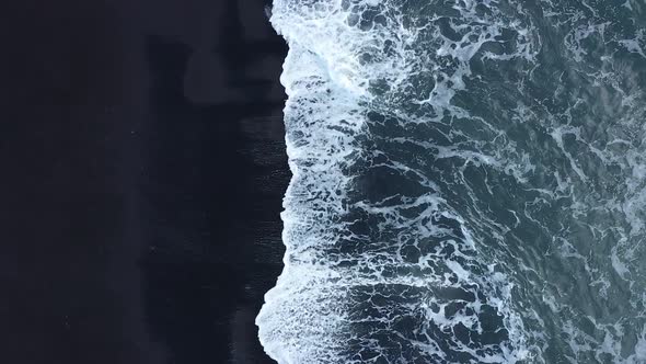Waves in the ocean. Black sand. Black beach. Waves on the black sand. The nature of Iceland. alt