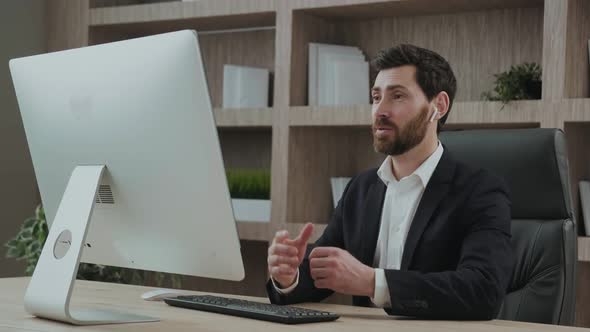 Good Looing Professional Business Coach Greeting His Students Online in Front of the Screen Waving alt