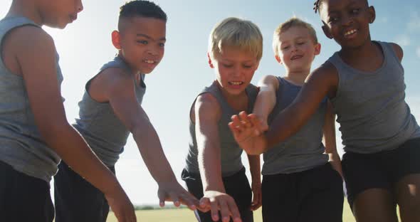 Video of happy diverse boys team clapping hands outdoors alt