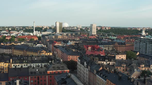 Panoramic aerial flying drone view of Södermalm black tin rooftops