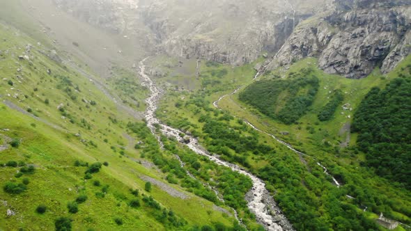 Mountain River Flowing Down From Rocks Through Green Gorge. Mountain Spring Flowing Down Gorge with alt