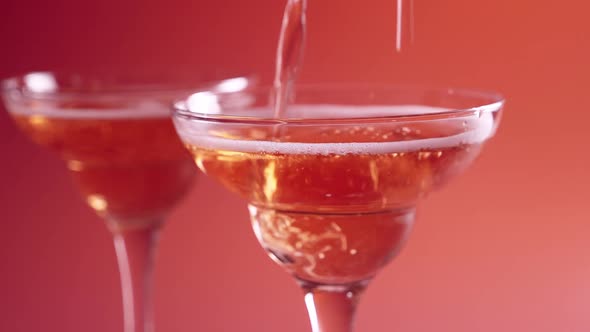 Closeup of Glass with Sparkling Rose Wine Decorated Gold Star Confetti Celebration Party alt