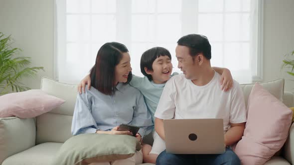 Asian family relaxing on the sofa in the living room, family relationship