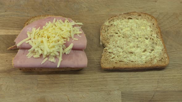 Putting cheese into a ham and cheese sandwich alt