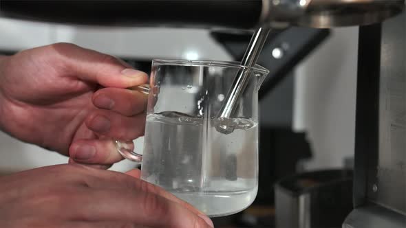 Hot Water Under the Pressure of Air is Poured Into a Cup alt