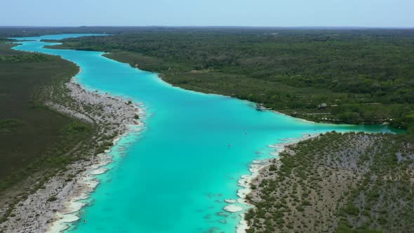 exotic turquoise blue Bacalar Lagoon in on a tropical sunny day in Mexico, aerial alt