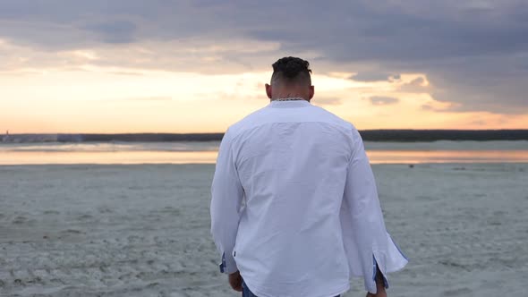 Brutal Man Walking on Beach