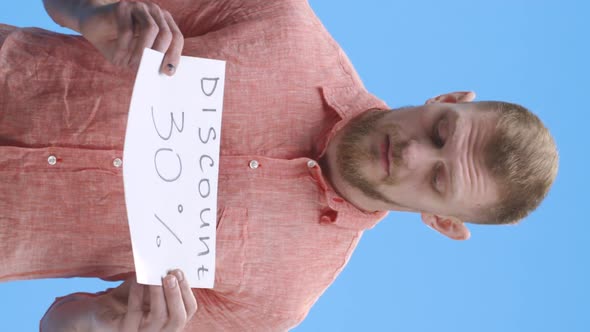 Young Man Holding Discount Sign alt