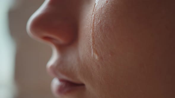 A Macro Tear Runs Down The Cheek Of A Young Girl The Girl Smiles Out Of Desperation Stock Footage 