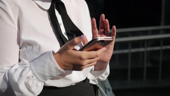 close-up business woman uses the phone, communicates on the Internet