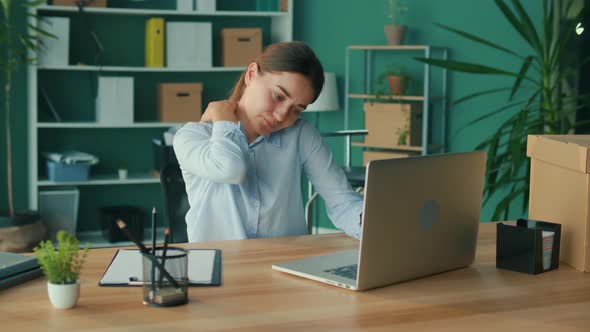 Focused Woman Work at Table With Laptop Suddenly Feeling Pain alt
