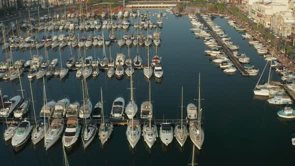Sailboats in the Harbour of Small Town on Malta Island, Aerial Tilt Down View alt