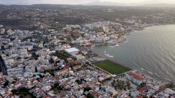 Aerial view Rethymno cityscape at sunset. Sports ground on sea coast beach Crete Greece