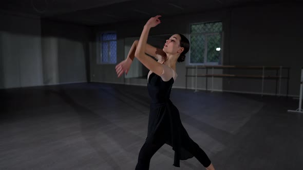 Concentrated Beautiful Woman Dancing in Studio Indoors Rehearsing Performance alt