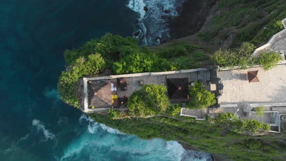 Aerial top down view going past a Temple and into ocean in Bali