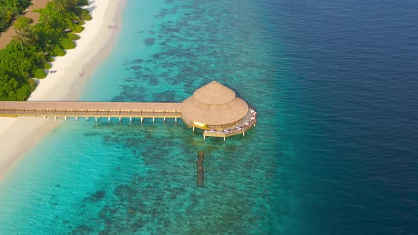 Aerial Top View on Water Bungalow with Leaf Roof and Turquoise Sea in Maldives Resort Island alt