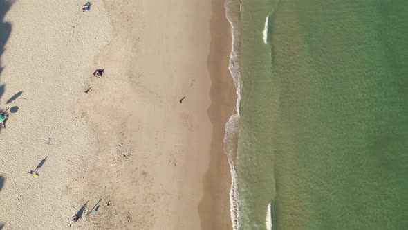 Aerial perspective of half golden sand and half aqua green sea ocean. alt