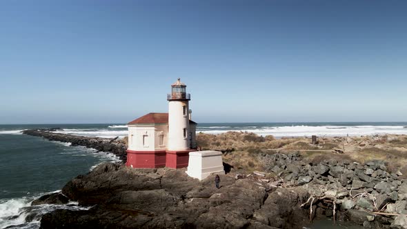 The historic Coquille River Lighthouse along the Oregon coast of the Pacific Ocean, aerial orbit alt