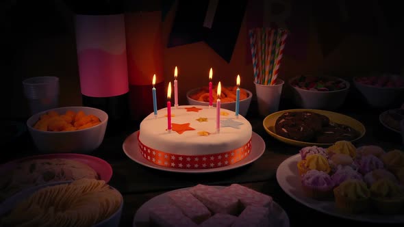 Rotating Around Birthday Cake And Snack Bowls In Dark Room alt