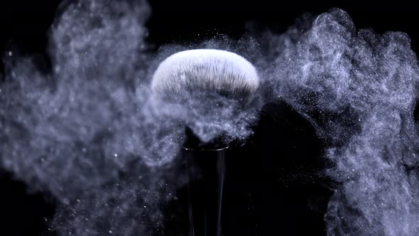 Super Slow Motion Shot of Blue Powder Falling From Facial Brush at 1000Fps alt