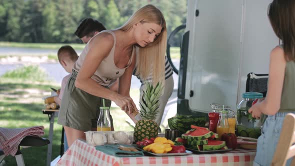 Handheld video of mother and daughter preparing food for picnic. Shot with RED helium camera in 8K. alt