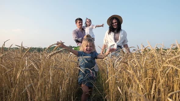 little girl in field runs to the camera and laughs merrily. alt