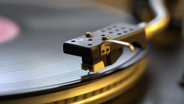 The Vinyl Record on DJ Turntable Record Player Close Up. The Rotating Plate and Stylus with the