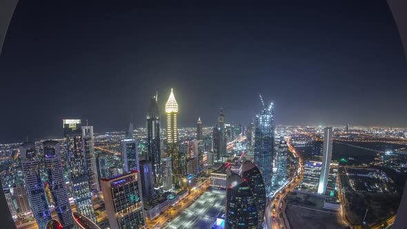 Skyline of the Buildings of Sheikh Zayed Road and DIFC Aerial Night Timelapse in Dubai UAE alt